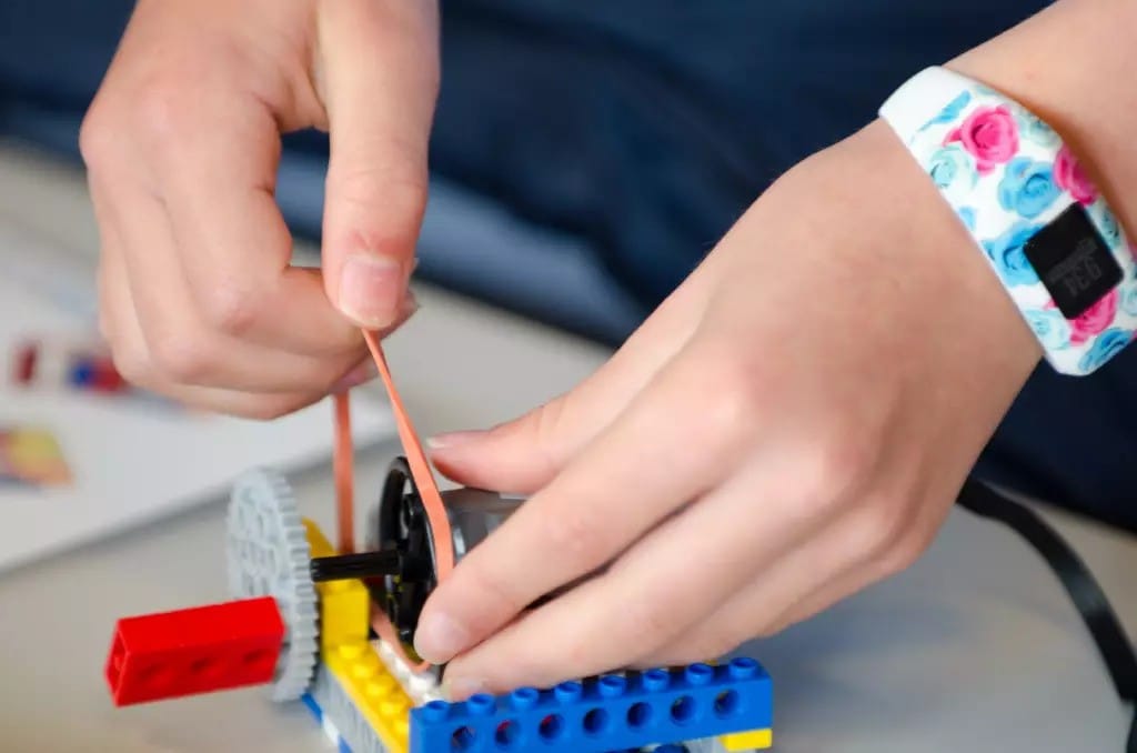 A student explores the science of vibration by building a LEGO compactor.
